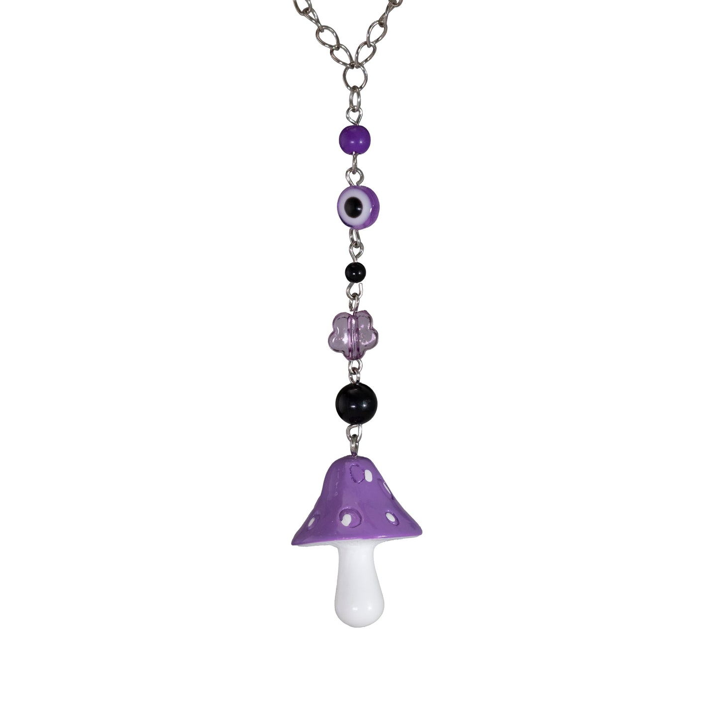 Hanging mushroom charm photographed on a white background
