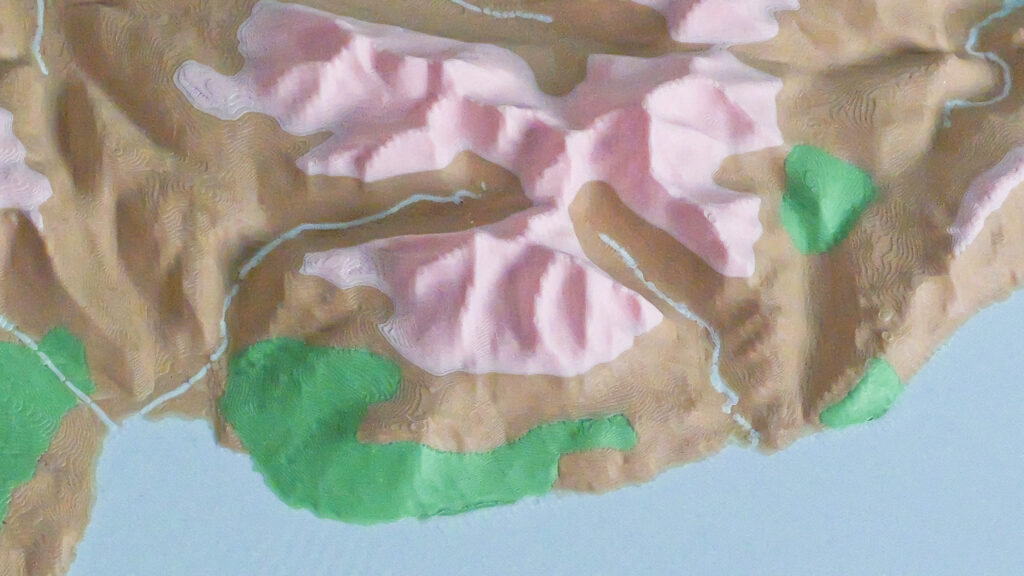 Close-up of a 3D printed relief map showing the Goatfell section of the Isle of Arran, with mountain ridges and height bands in colour.
